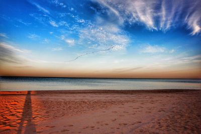 Scenic view of beach against sky during sunset