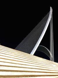 Low angle view of illuminated bridge against sky at night