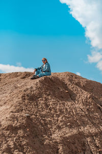 Young girl sitting on the sand