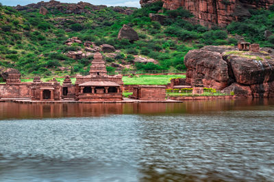 Temple on the shores of lake with mountain in background