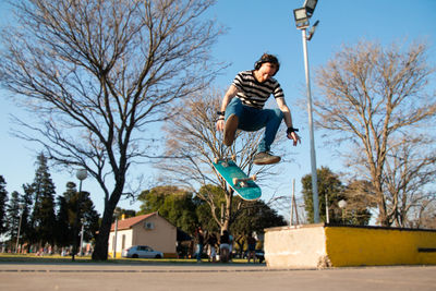 Skateboarder trick in skatepark