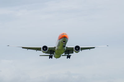 Low angle view of airplane flying against sky