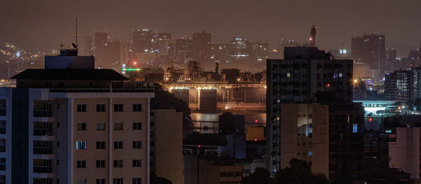 High angle view of illuminated buildings in city at night