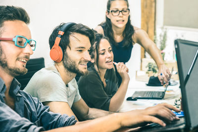 Happy colleagues working at desk in office