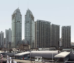 Modern buildings in city against clear sky