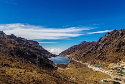 Scenic view of mountains against blue sky