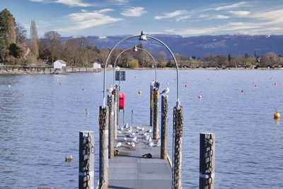Pier over lake against sky