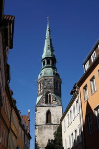 Low angle view of kreuzkirche against clear blue sky in city