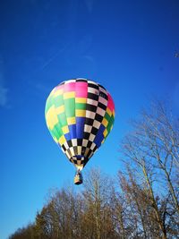 Low angle view of hot air balloon against blue sky