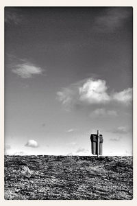 Low angle view of lighthouse against cloudy sky