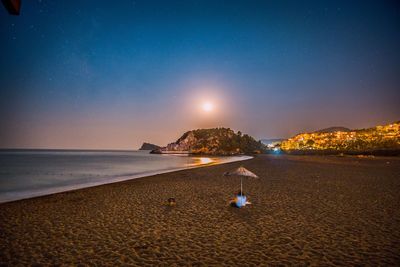 Scenic view of sea against clear sky at night