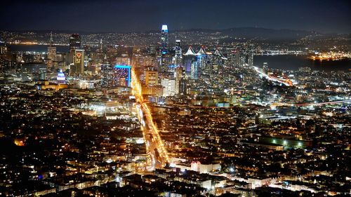 High angle view of illuminated city buildings at night