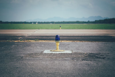 Surface level of road on field against sky