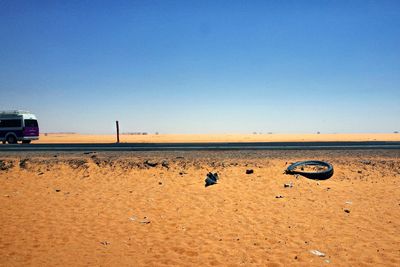 Scenic view of beach against clear blue sky