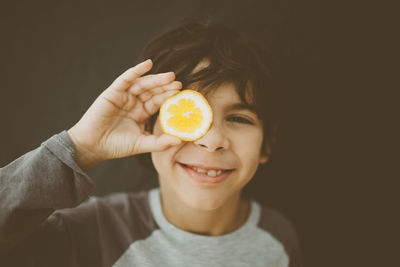 Close-up of boy holding fruit