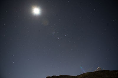 Low angle view of mountain against star field in sky at night