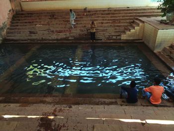 High angle view of men swimming in water