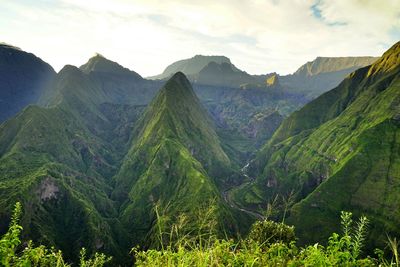 Scenic view of mountains against cloudy sky