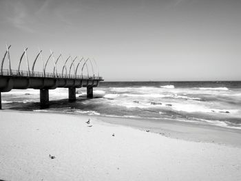 Scenic view of beach against clear sky