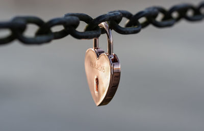 Close-up of heart shape padlock hanging on chain