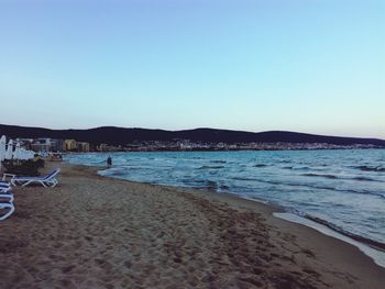 Scenic view of beach against clear blue sky