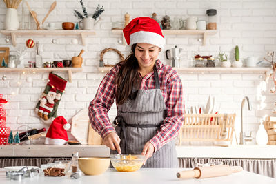 Portrait of woman preparing food at home