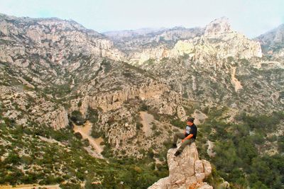 Man standing on rock against mountain