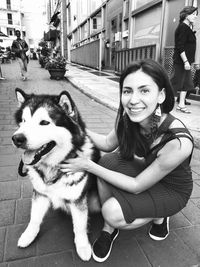 Portrait of young woman with dog