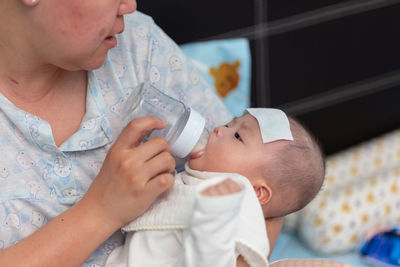 Close-up of mother carrying daughter at home