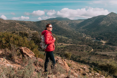 Full length of man standing on mountain against sky