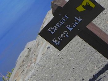 Information sign against blue sky