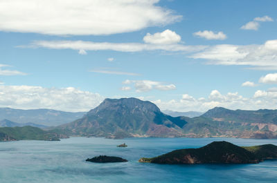 Scenic view of mountains against cloudy sky