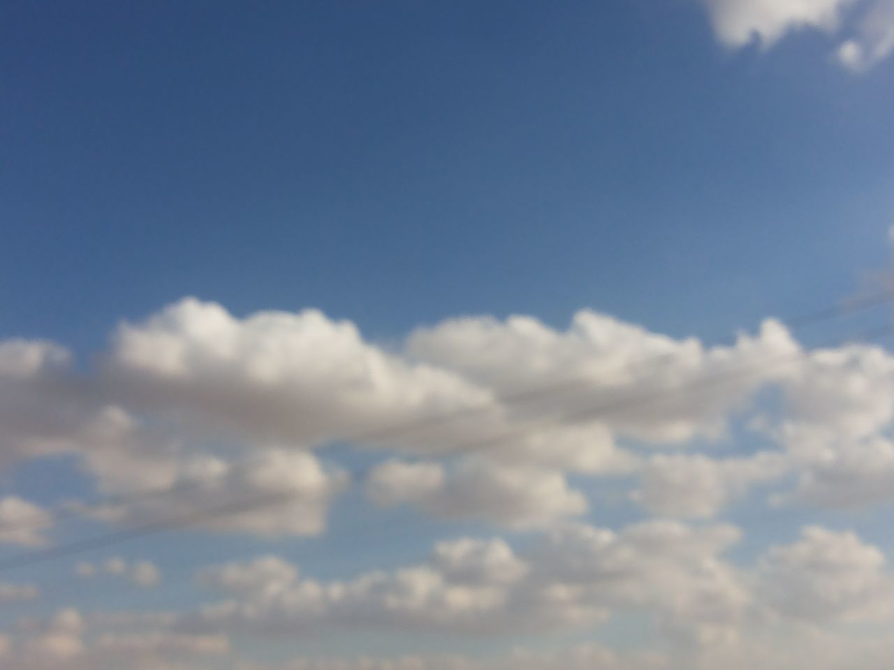 sky, blue, beauty in nature, low angle view, cloud - sky, tranquility, scenics, sky only, tranquil scene, nature, cloud, cloudscape, white color, idyllic, cloudy, day, outdoors, backgrounds, copy space, no people