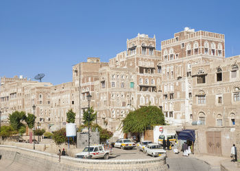 Buildings in city against clear sky