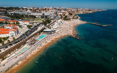 High angle view of cityscape by sea against sky