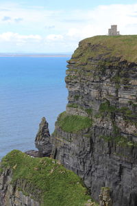 Rock formations by sea against sky