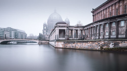 View of berlin cathedral by footbridge against sky