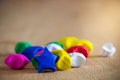 Close-up of multi colored stars on table