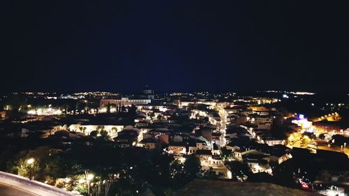 High angle view of city lit up at night