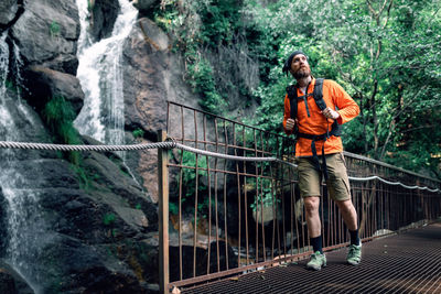 Full length of man standing on footbridge