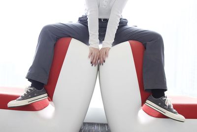 Low section of man sitting on chair