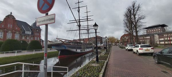 View of canal by buildings against sky