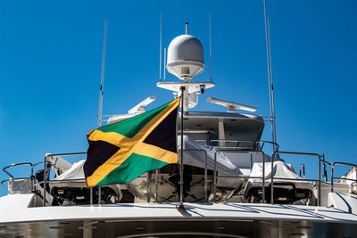 Low angle view of sailboat against clear blue sky