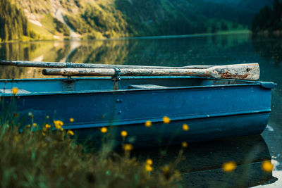 Close-up of fishing boat moored in lake