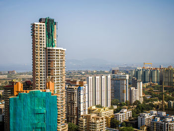 Modern buildings in city against clear sky