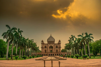 Historic building against cloudy sky at sunset