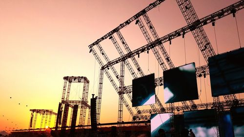 Low angle view of cranes against clear sky