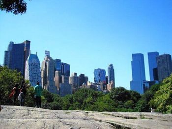 Low angle view of modern buildings against blue sky