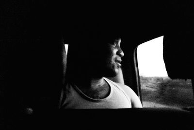 Portrait of young man looking away at window