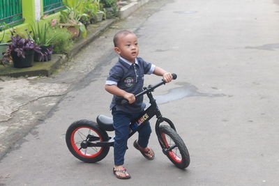 Portrait of toddler boy riding a pushbike